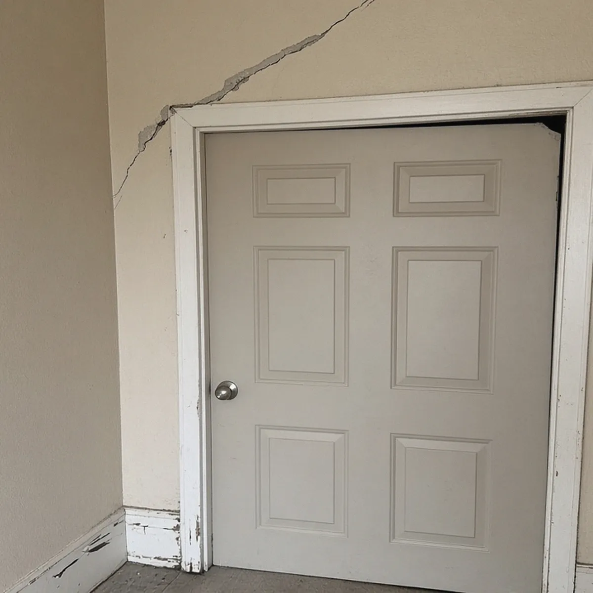 Door out of square with a drywall crack above it